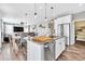 Open-concept kitchen featuring an island, stainless steel appliances, and adjacent living area at 2594 Scoter Ln, Castle Rock, CO 80104
