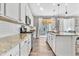 Bright and spacious kitchen featuring white cabinets, granite countertops, and stainless appliances at 2594 Scoter Ln, Castle Rock, CO 80104