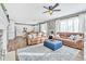 Spacious living area featuring hardwood floors, leather sofas, an ottoman, and an open layout at 2594 Scoter Ln, Castle Rock, CO 80104