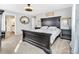 Spacious main bedroom with dark wood furnishings, ceiling fan, and a private ensuite bathroom at 2594 Scoter Ln, Castle Rock, CO 80104