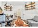 Home office with hardwood floors, modern shelves, a desk, and a comfortable chair at 2594 Scoter Ln, Castle Rock, CO 80104