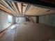 Unfinished basement with exposed ceiling joists, concrete foundation walls, and a window well providing natural light at 30 Waterford St, Erie, CO 80516