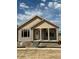 New home featuring a charming front porch with stone pillars and a combination of lap siding and shake at 30 Waterford St, Erie, CO 80516