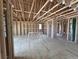 Spacious, unfinished room featuring exposed framing, high ceilings, and natural light ready to be customized at 30 Waterford St, Erie, CO 80516