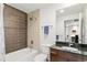 Bathroom featuring a shower-tub combo, sleek vanity with a dark countertop, and neutral tiling at 891 14Th St # 1408, Denver, CO 80202