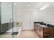 Modern bathroom featuring dual sinks, granite countertops, and a glass enclosed shower at 891 14Th St # 1408, Denver, CO 80202
