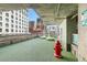 Outdoor dog park with artificial turf and play equipment for pets, set against a city backdrop at 891 14Th St # 1408, Denver, CO 80202