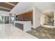 Elegant reception desk with marble counters, a modern wood accent wall, and tiled floors at 891 14Th St # 1408, Denver, CO 80202