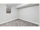 Finished basement area with a small window and gray carpet at 3210 Magnolia St, Denver, CO 80207