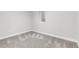 Empty basement with neutral carpet and white walls featuring a window for natural light at 3210 Magnolia St, Denver, CO 80207