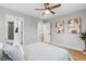 Bedroom featuring wood floors, ceiling fan and doors to the ensuite bathroom and closet at 3210 Magnolia St, Denver, CO 80207