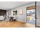 Bright dining area featuring hardwood floors, modern decor, and a view of the outdoors at 3210 Magnolia St, Denver, CO 80207