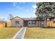 Charming home featuring a well-manicured lawn, stone walkway, and inviting exterior paint scheme at 3210 Magnolia St, Denver, CO 80207