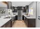 Modern kitchen featuring stainless steel appliances, dark cabinetry, and white countertops at 3210 Magnolia St, Denver, CO 80207