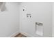 A utility room, featuring washer and dryer hookups, and modern wood-look flooring at 3210 Magnolia St, Denver, CO 80207
