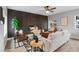 Cozy living room with modern furniture, a ceiling fan, and a feature wall with a fireplace at 3210 Magnolia St, Denver, CO 80207