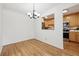 Bright dining area with hardwood floors and view to the kitchen with stainless appliances at 660 S Alton Way # 3B, Denver, CO 80247