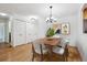 Dining room with hardwood floors, modern chandelier, and seating for six at 660 S Alton Way # 3B, Denver, CO 80247