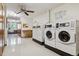 Clean laundry room featuring multiple machines and lots of light at 660 S Alton Way # 3B, Denver, CO 80247