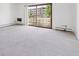 Carpeted living room with balcony access. Lots of natural light at 660 S Alton Way # 3B, Denver, CO 80247