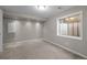 A cozy basement room with neutral carpeting, recessed lighting, and natural light from a window well at 5276 S Danube St, Centennial, CO 80015