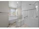 This renovated bathroom features a glass shower with bench and a large soaking tub at 5276 S Danube St, Centennial, CO 80015