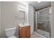 Bathroom featuring a tiled shower, wood vanity, and ample storage space at 5276 S Danube St, Centennial, CO 80015