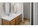 This renovated bathroom features a double sink vanity with marble countertops and wood cabinets at 5276 S Danube St, Centennial, CO 80015