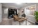 Staged basement home office with a wooden desk, black bookshelf, and accent rug in neutral decor at 5276 S Danube St, Centennial, CO 80015