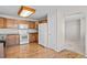A brightly-lit kitchen with wood floors, stainless appliances, and a doorway leading to another room in the house at 5276 S Danube St, Centennial, CO 80015