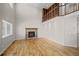 Bright living room featuring a cozy fireplace, high ceilings, and beautiful hardwood floors at 5276 S Danube St, Centennial, CO 80015