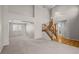 Spacious living room with high ceilings, wooden staircase, and a seamless transition to the dining area at 5276 S Danube St, Centennial, CO 80015