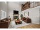 Living room with a cozy fireplace, hardwood floors, and a view of the bookshelf on the upper level at 5276 S Danube St, Centennial, CO 80015
