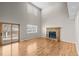 Spacious living room featuring hardwood floors, a brick fireplace, and sliding glass doors to the deck at 5276 S Danube St, Centennial, CO 80015