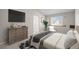 Stylishly decorated bedroom featuring a large window, an ensuite bathroom, and a dresser at 5276 S Danube St, Centennial, CO 80015