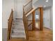 Elegant foyer showcases a staircase with wooden railings, complemented by hardwood and carpeted floors at 5276 S Danube St, Centennial, CO 80015