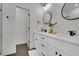 Bright bathroom features double vanities, round mirrors, and modern fixtures at 8530 W 52Nd Ave # A1, Arvada, CO 80002