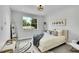 Serene bedroom with plush bedding, stylish lighting, and a large window offering natural light and views at 8530 W 52Nd Ave # A1, Arvada, CO 80002