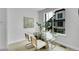 Bright dining room with modern table and chairs adjacent to a large window at 8530 W 52Nd Ave # A1, Arvada, CO 80002