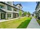 Modern two-story townhouse featuring a well-manicured lawn and a sidewalk leading to the entrance at 8530 W 52Nd Ave # A1, Arvada, CO 80002