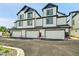 Modern townhome exterior with three garage doors and manicured landscaping at 8530 W 52Nd Ave # A1, Arvada, CO 80002
