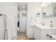 Bright bathroom showcasing beadboard walls, a vanity, and a mirror with integrated lighting at 12360 W Nevada Pl # 206, Lakewood, CO 80228