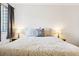 Well-lit bedroom boasts a large window, soft carpet, and stylish bedside tables and lamps at 12360 W Nevada Pl # 206, Lakewood, CO 80228