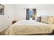 Bright bedroom featuring soft carpeting, a large window, and stylish lamps for a warm ambiance at 12360 W Nevada Pl # 206, Lakewood, CO 80228
