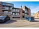 Multi-story apartment building with brick facade, balconies, and parking for residents at 12360 W Nevada Pl # 206, Lakewood, CO 80228