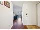 Inviting entryway with hardwood floors leading into a vaulted living space with balcony access at 12360 W Nevada Pl # 206, Lakewood, CO 80228