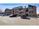 Condos feature brick accents, balconies, and parking, creating an inviting exterior, complemented by blue skies at 12360 W Nevada Pl # 206, Lakewood, CO 80228