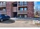 Brick apartment building exterior with a parking area, offering convenient access to units at 12360 W Nevada Pl # 206, Lakewood, CO 80228