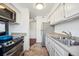 Beautiful kitchen with stainless appliances, white cabinets, and an open layout at 12360 W Nevada Pl # 206, Lakewood, CO 80228