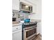 This remodeled kitchen features stainless steel appliances, granite countertops, and modern cabinetry at 12360 W Nevada Pl # 206, Lakewood, CO 80228